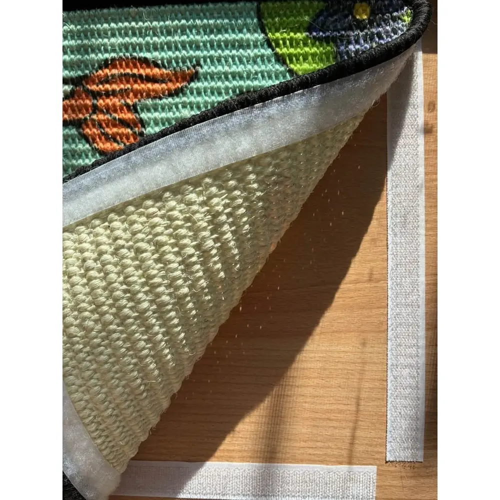 Close view of a Koi scratch panel lifted from the wooden easel, showing the hook-and-loop fastening strips underneath.