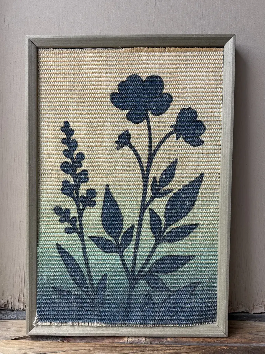 Earlier framed flower sisal sample from the same manufacturer, in household use since December 2025.