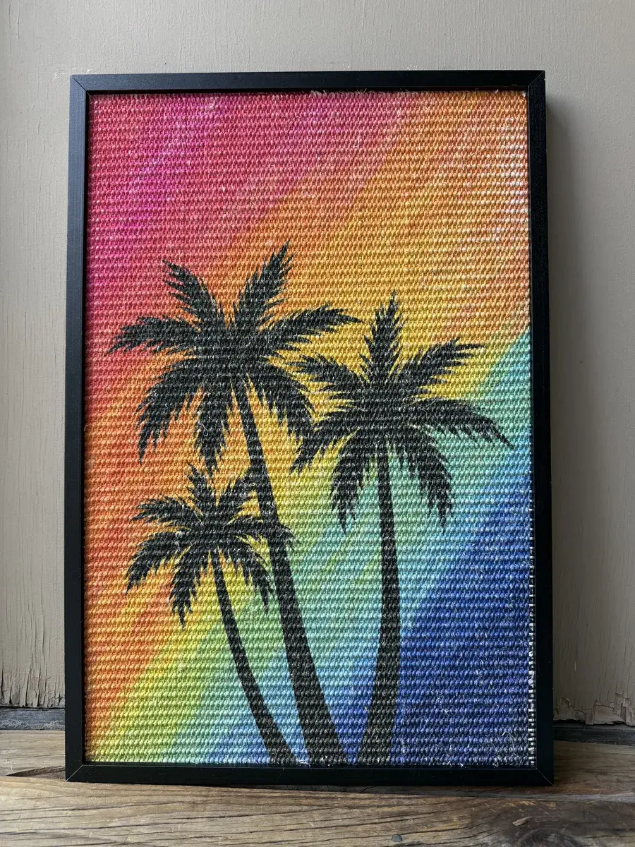 Earlier framed palm-tree sisal sample from the same manufacturer, in household use since December 2025.